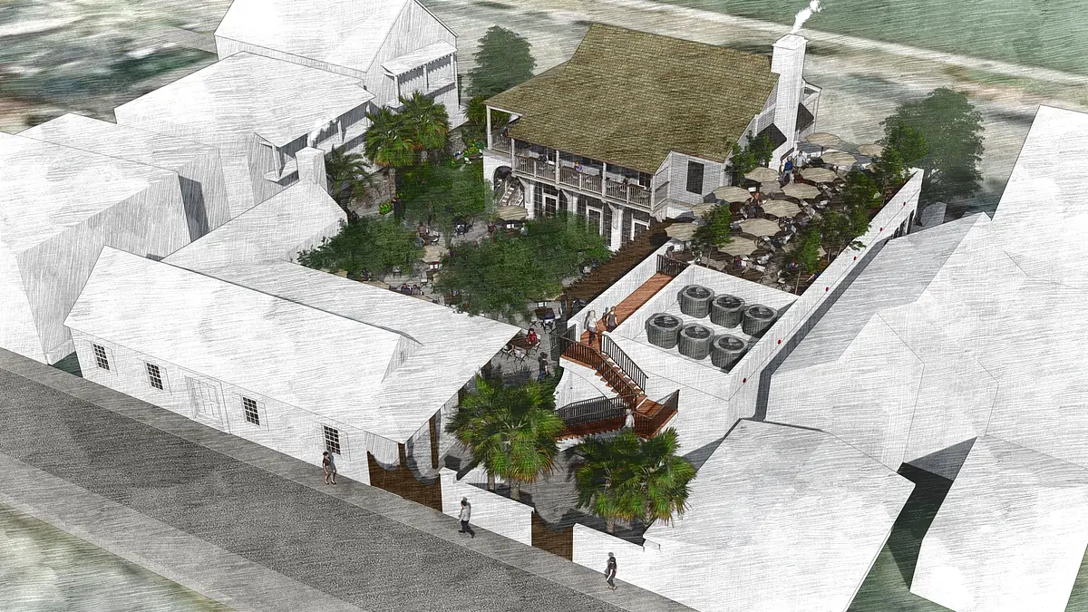 Aerial view of a property with structures, terrace, outdoor seating, trees, and pathways.