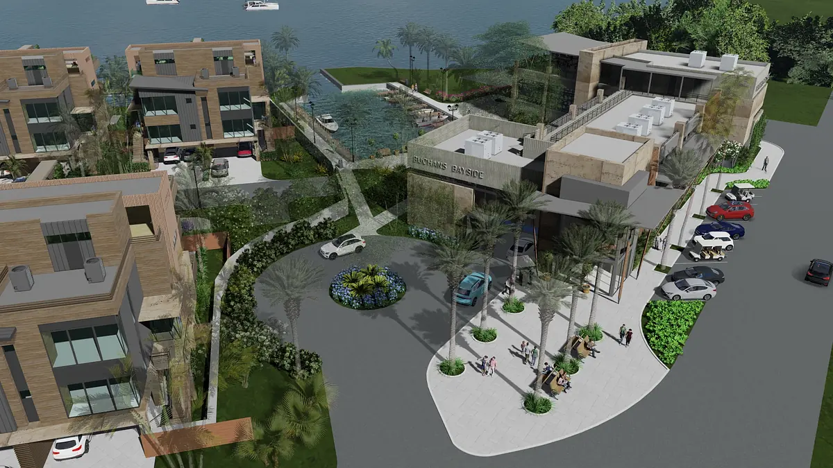 Exterior view of a modern building complex with landscaped pathways, water feature, and vehicles.