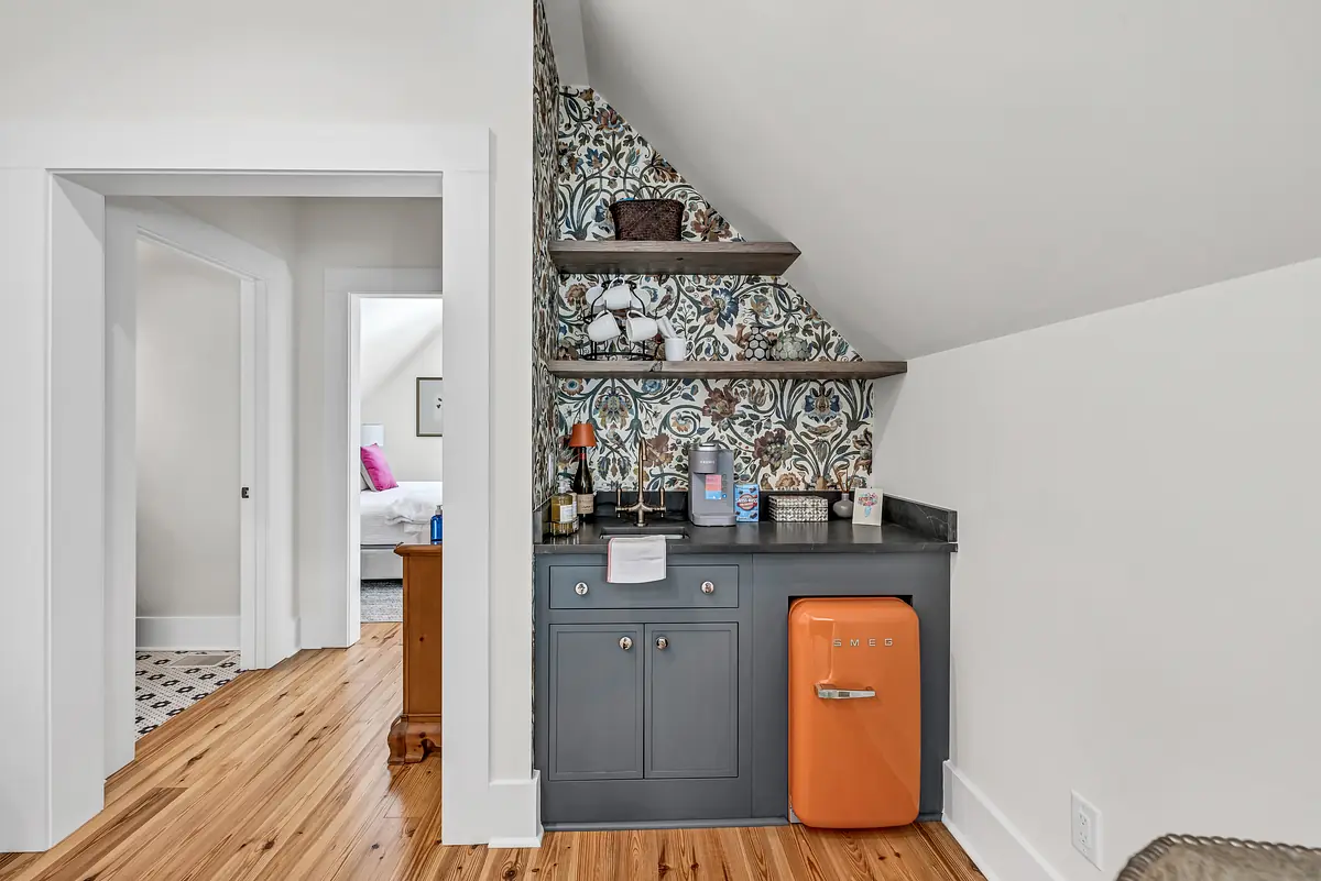 Butler's pantry with gray cabinetry, orange refrigerator, dark countertop, and open shelving