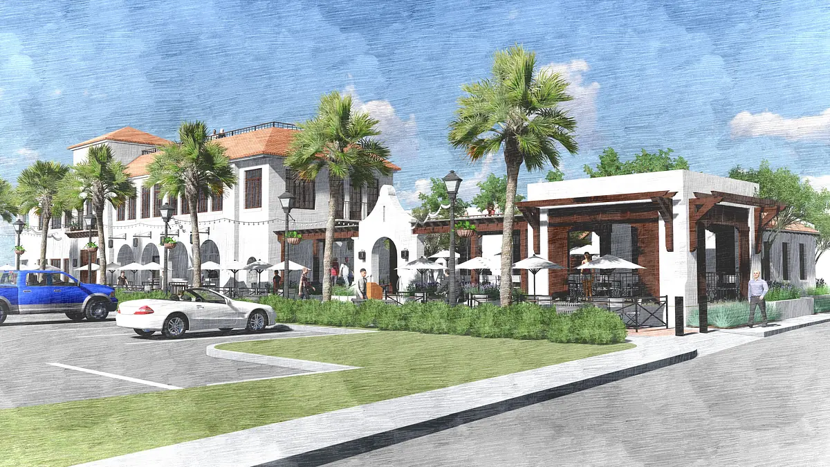 Exterior front view of a commercial building with palm trees, outdoor seating, and tile roofing.