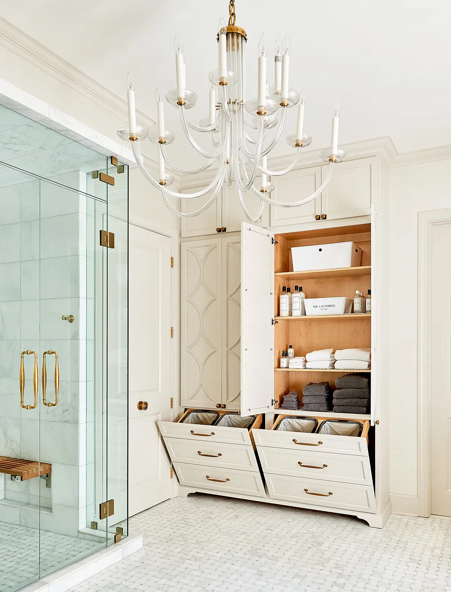 Bathroom with glass shower, chandelier, built-in storage, and marble flooring