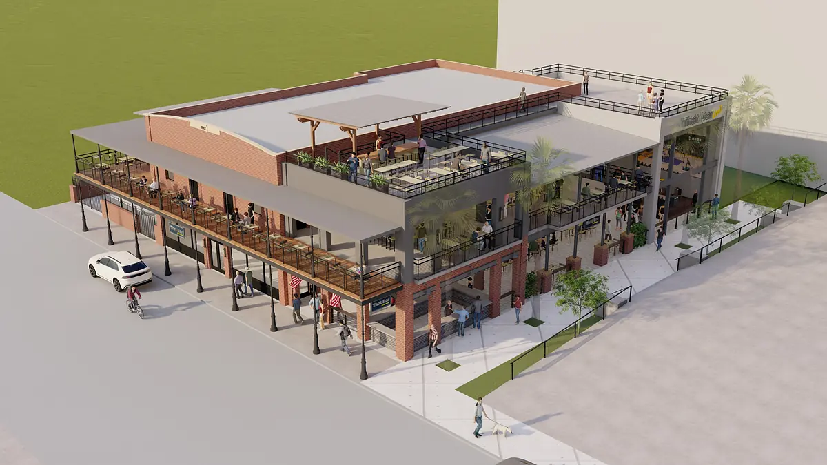 Multi-level commercial building with outdoor seating, large windows, and a brick facade.