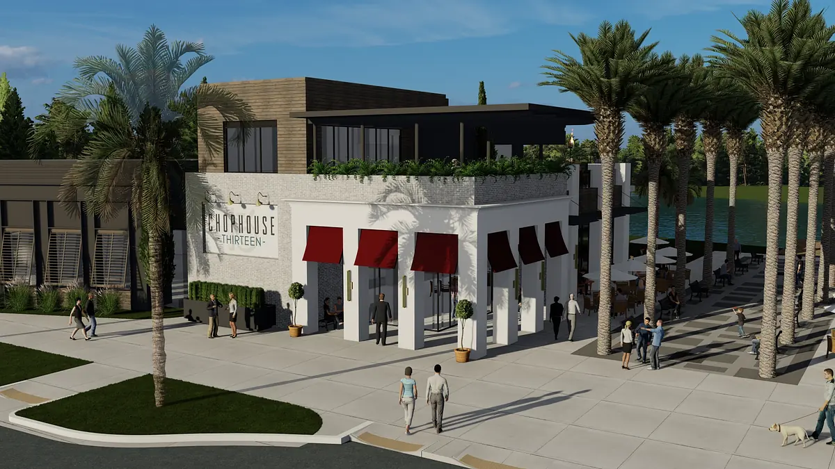 Commercial building with white stucco facade, red awnings, glass doors, palm trees, and a sidewalk.