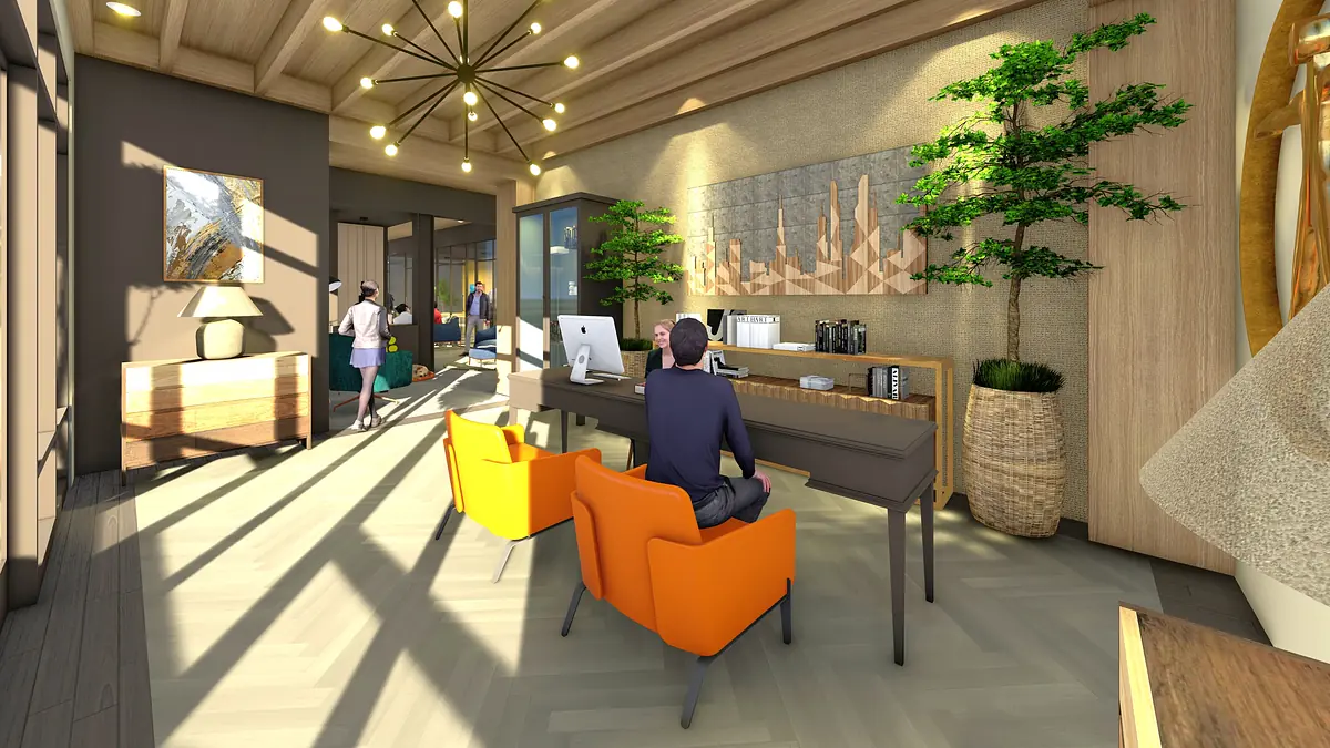 Office with desk, computer, orange chairs, wall art, plants, and natural lighting from large windows.