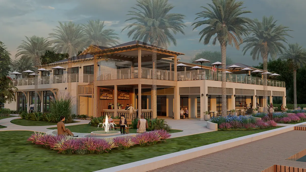 Exterior rear view of a two-story building with patio, dining areas, palm trees, fountain, and landscaping.
