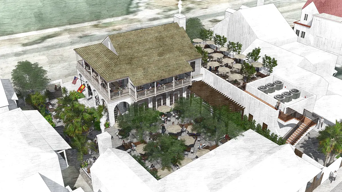 Outdoor gathering space with a building, seating areas, palm trees, and steps leading to a raised platform.