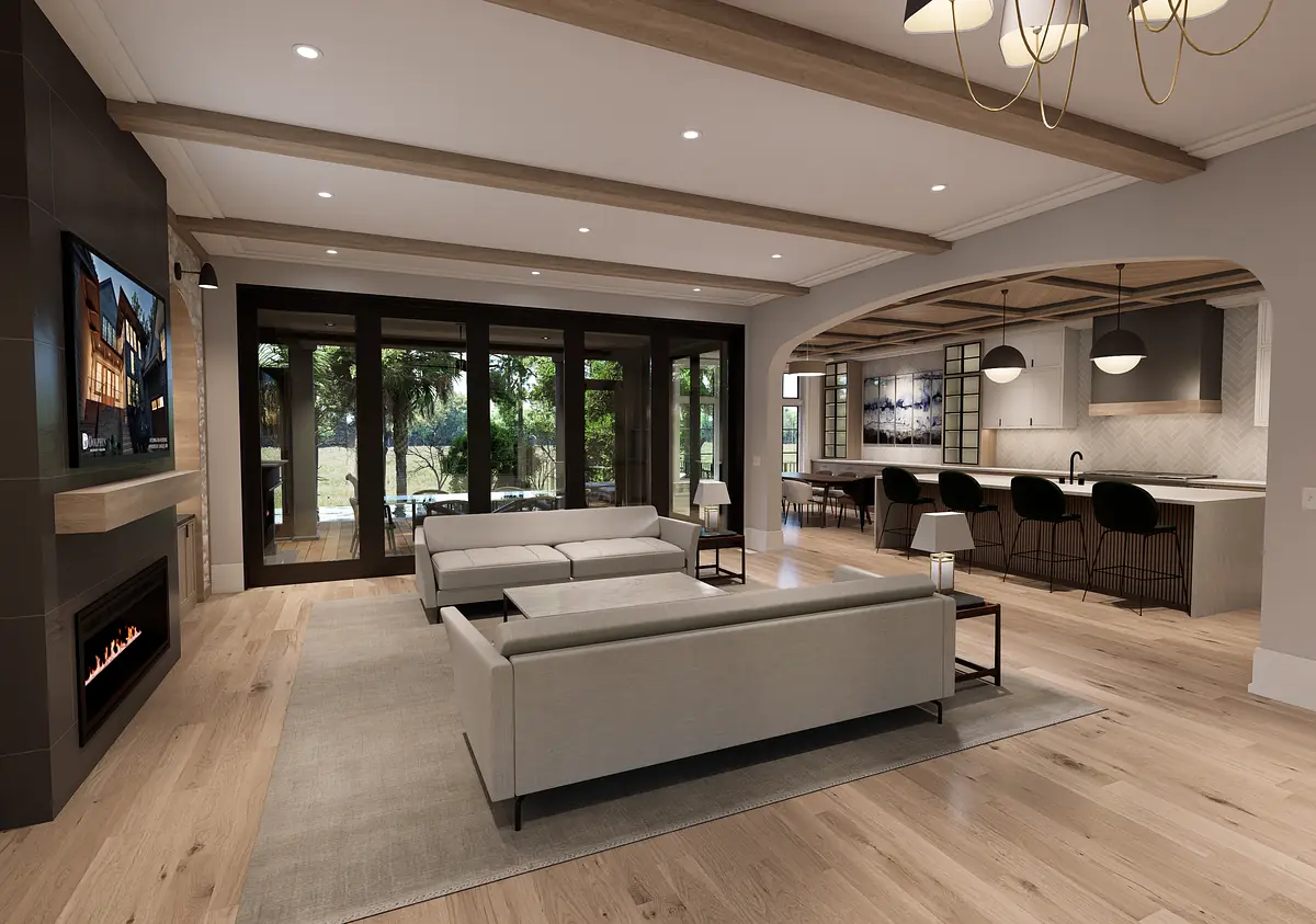 Living room with gray sofas, glass coffee table, fireplace, large windows, and adjacent kitchen area with bar stools.