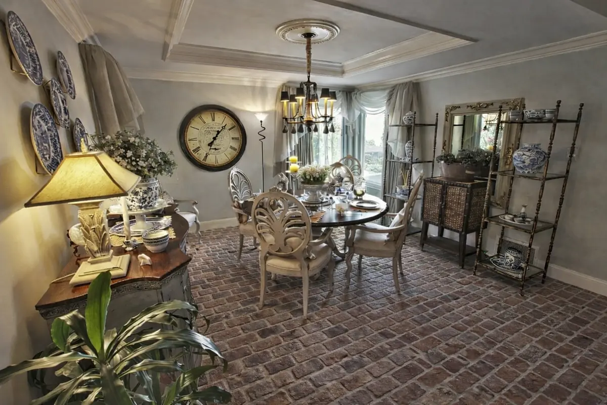 Dining room with round table, chairs, decorative plates, vintage clock, and sideboard.