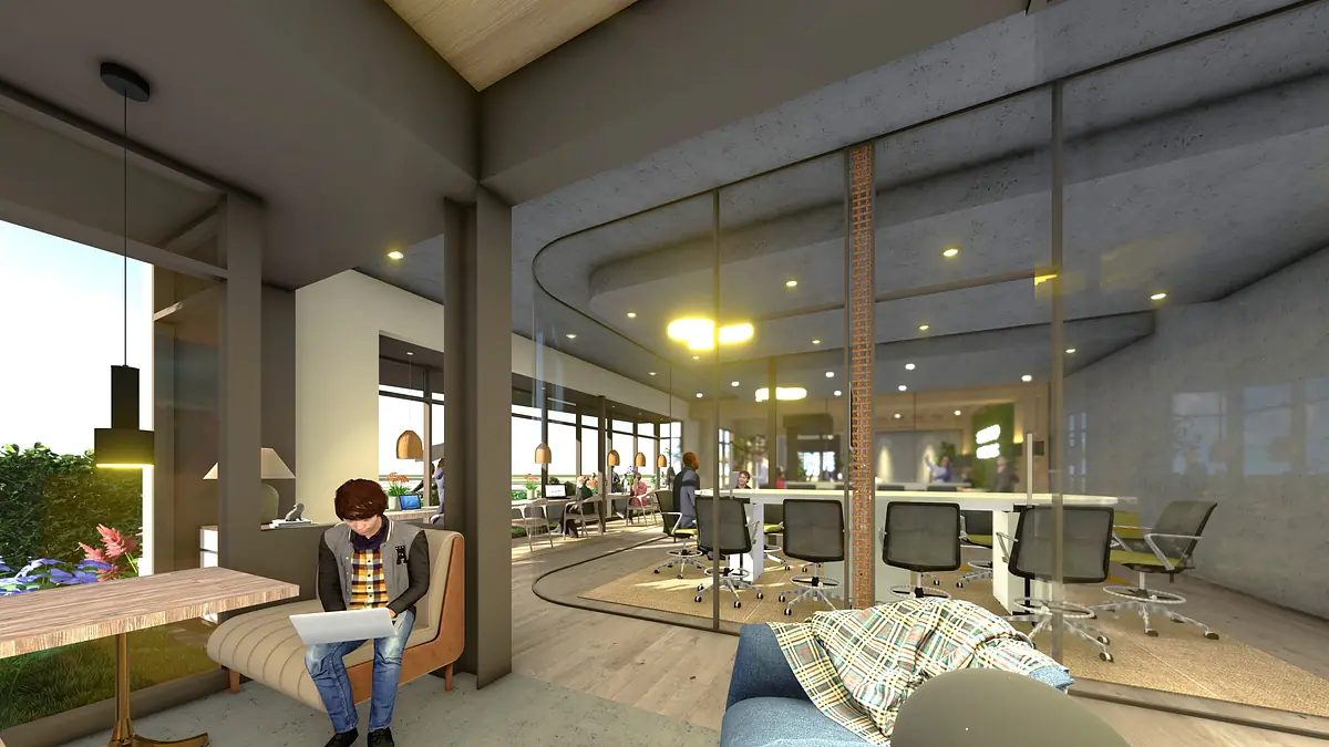 Office space with large windows, circular conference table, office chairs, and man using a laptop at a wooden table