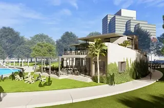 Exterior view of a building with pool area, lawn, and lounge chairs in a city setting.
