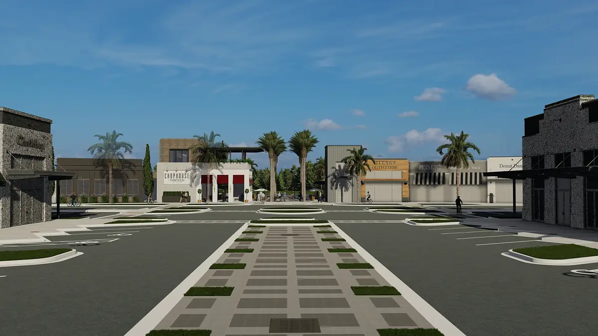 Outdoor plaza with paved road, palm trees, and various building facades.