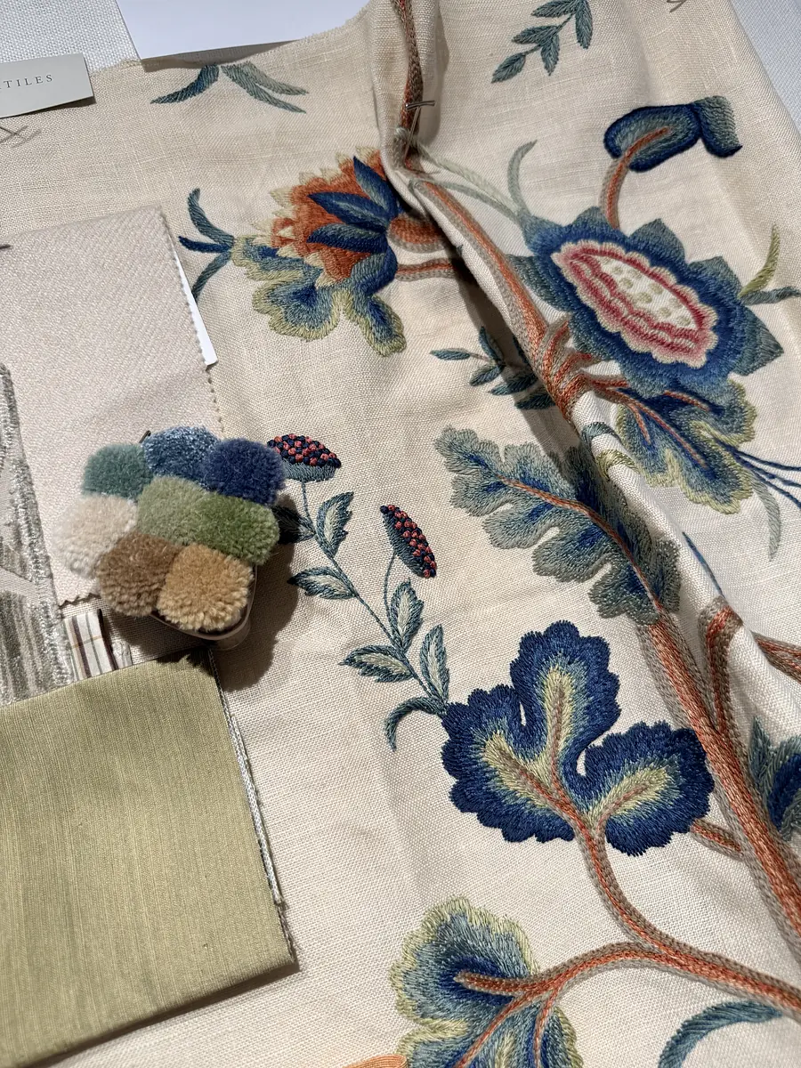 Collection of fabric swatches with floral patterns and additional textile samples in various colors.