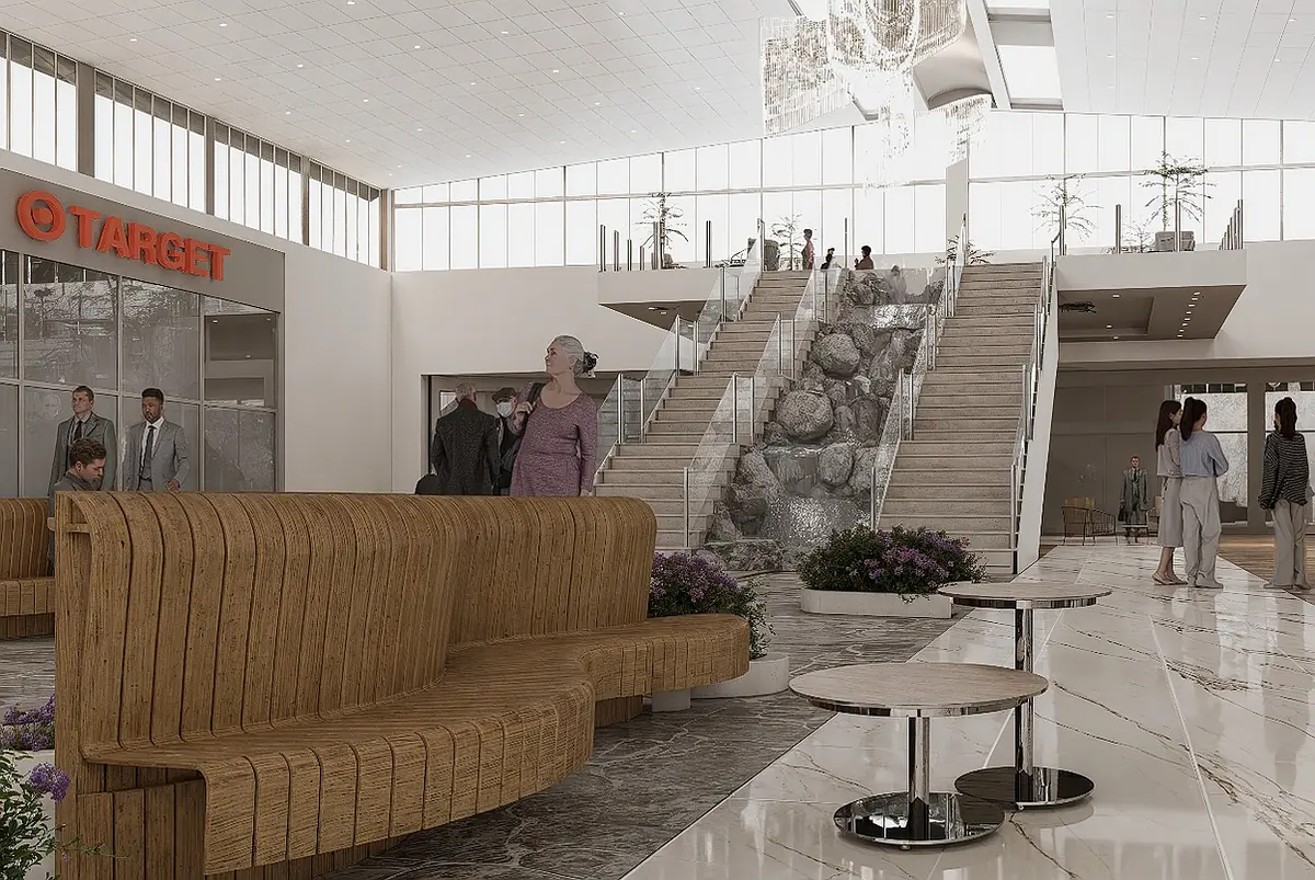 Interior space with wooden seating, round tables, plants, staircase, water feature, and large windows