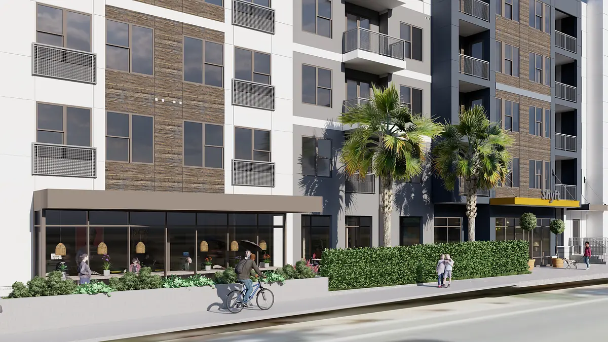 Exterior front view of a building with large windows, balconies, and wooden accents, with people outside.