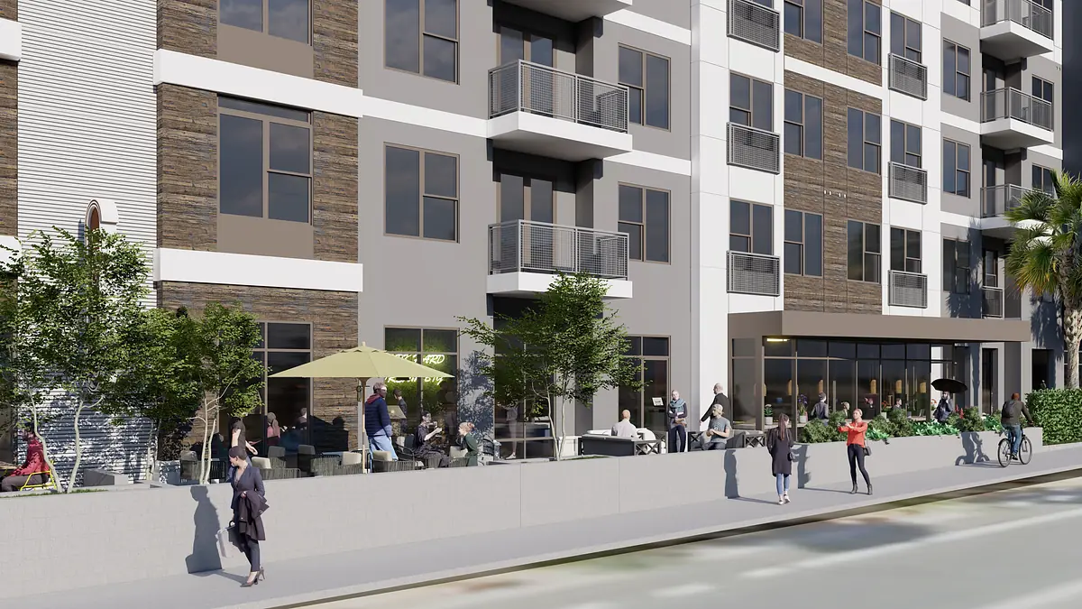 Exterior front view of multi-story building with patio area, large windows, and people gathered outside.