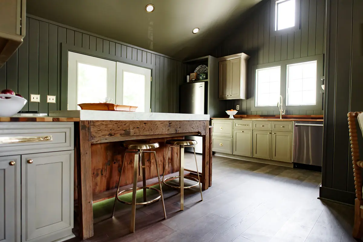Kitchen with central island, gray cabinetry, stainless steel appliances, double windows, and dark hardwood flooring
