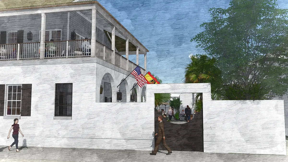Exterior front view with white building, arches, balcony, flags, and pathway with pedestrians