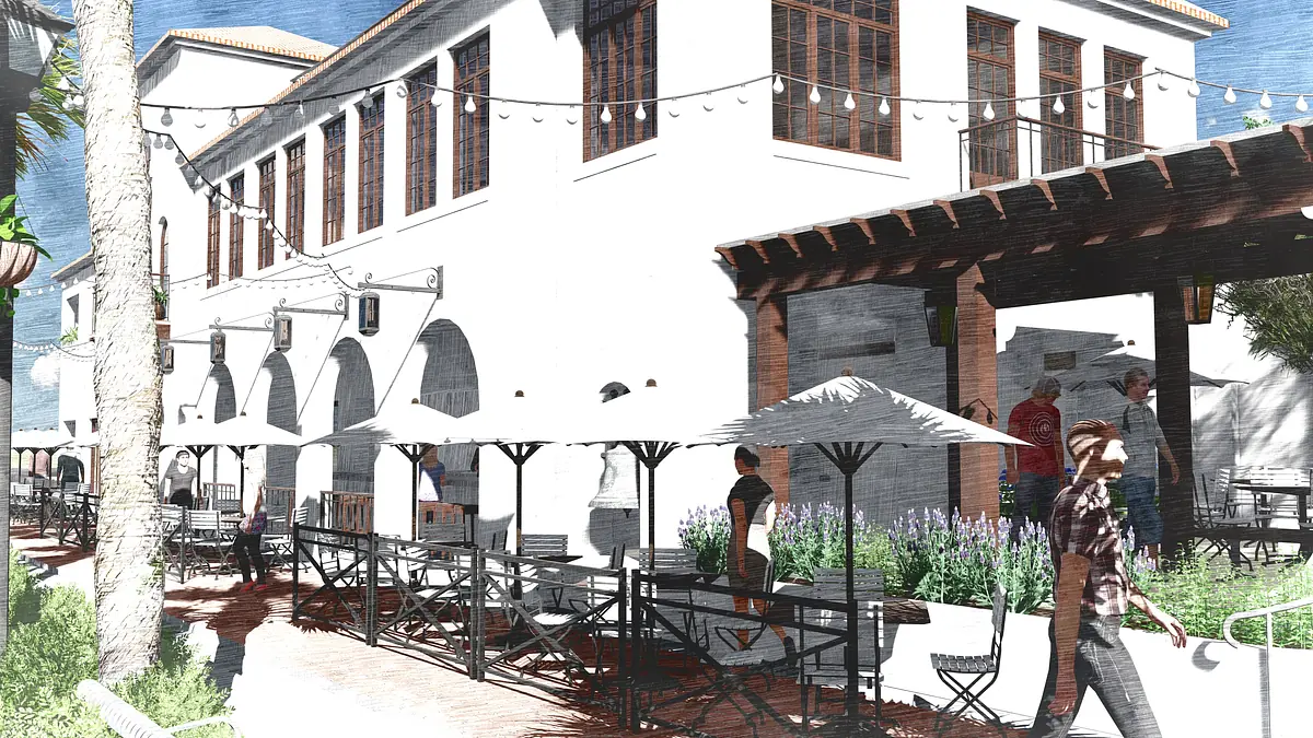 Patio with metal tables, chairs, umbrellas, lavender landscaping, and a building with arched windows in the background