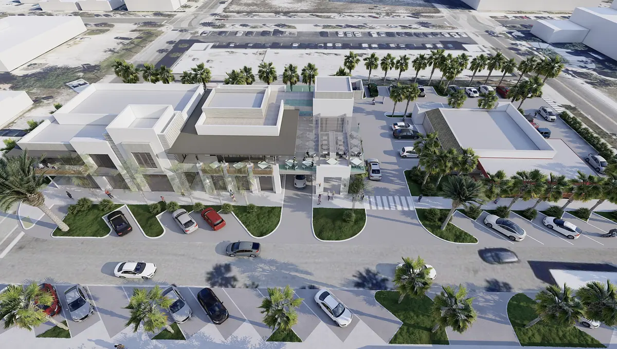 Exterior view of a commercial building complex with palm trees, parking areas, and multiple structures.