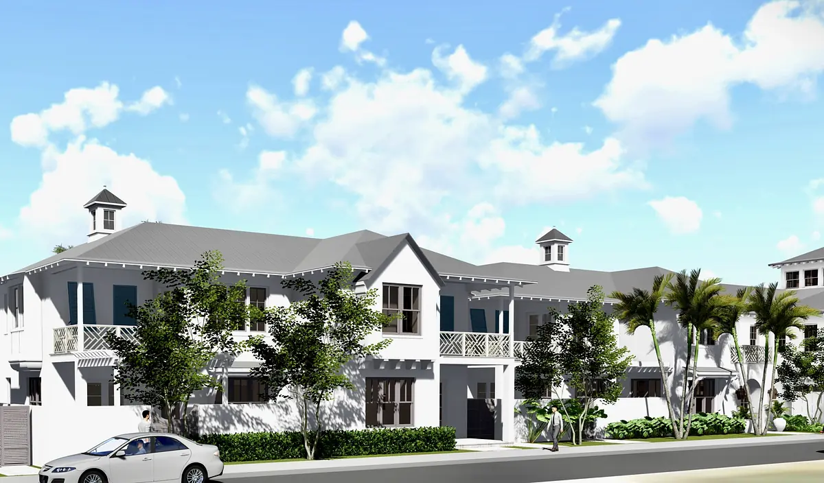 Front exterior of a building with white walls, gray roofs, windows, porch, and landscaping.