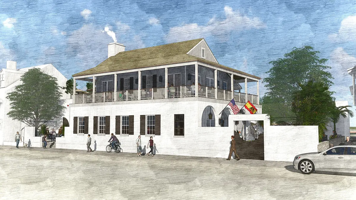 Exterior front of a two-story building with porch, flags, people, car, and greenery.