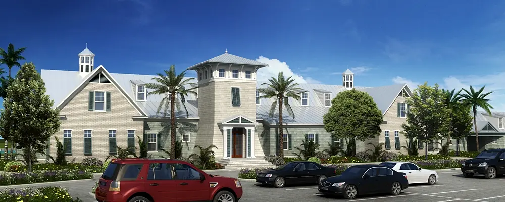 Exterior facade of a stone building with gabled roofs, large windows, and a parking lot.