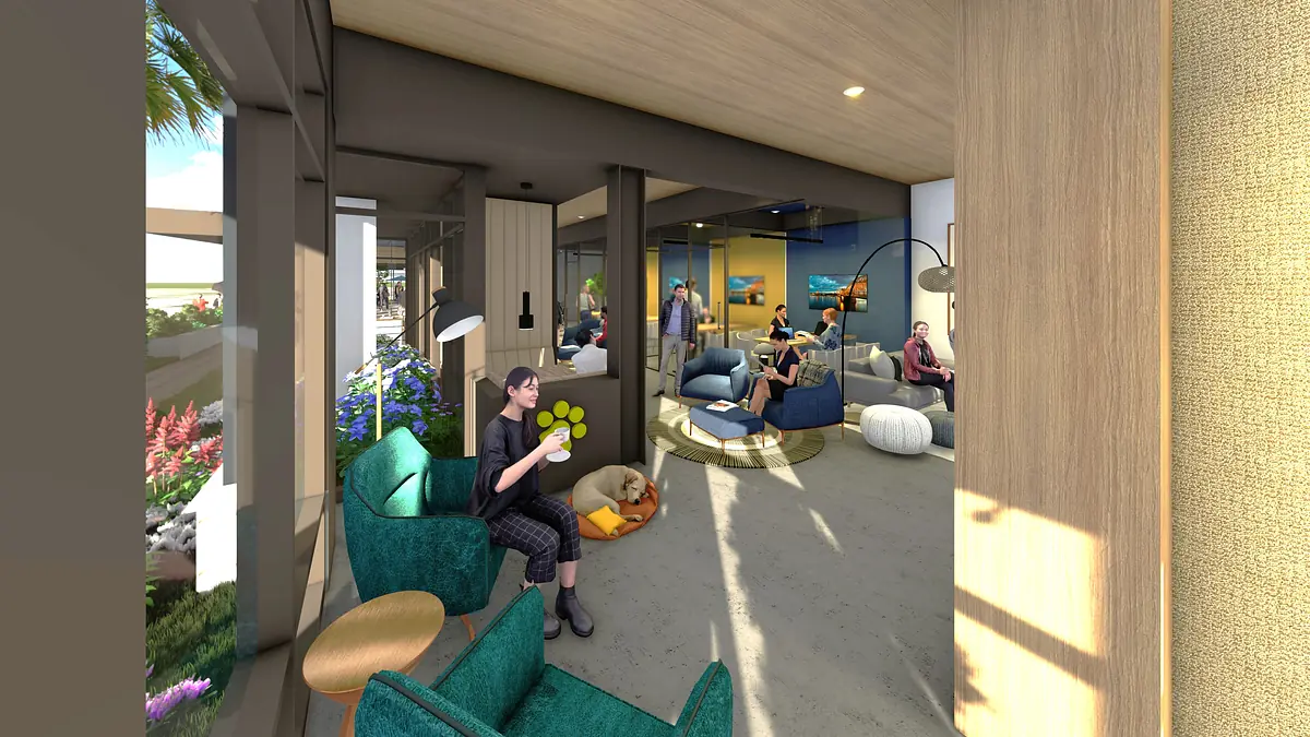 Living room with teal armchairs, wooden table, poufs, dog bed, and large windows with natural light.