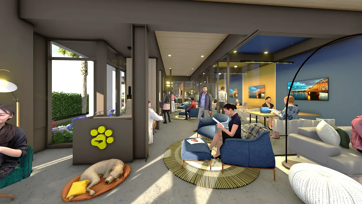 Living room with blue chairs, gray sofa, round coffee table, large rug, artwork, and natural light from windows.