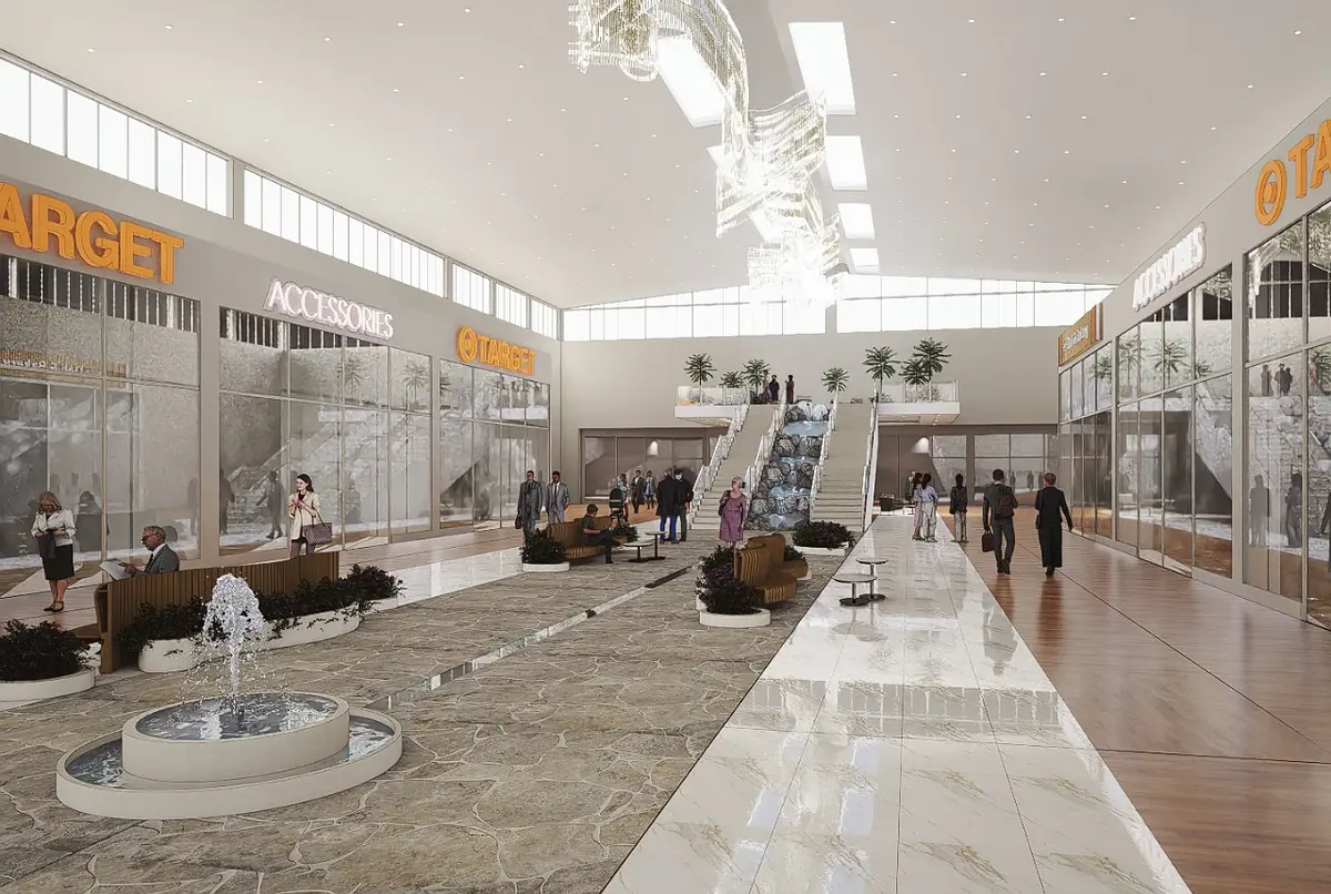 Commercial interior with water fountain, seating areas, glass storefronts, and staircase leading to upper level.