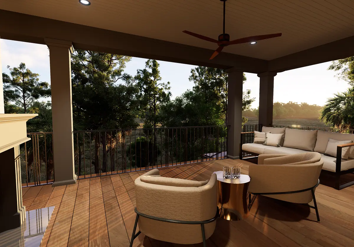 Deck with beige sectional sofa, armchairs, metallic table, stone fireplace, and surrounding greenery