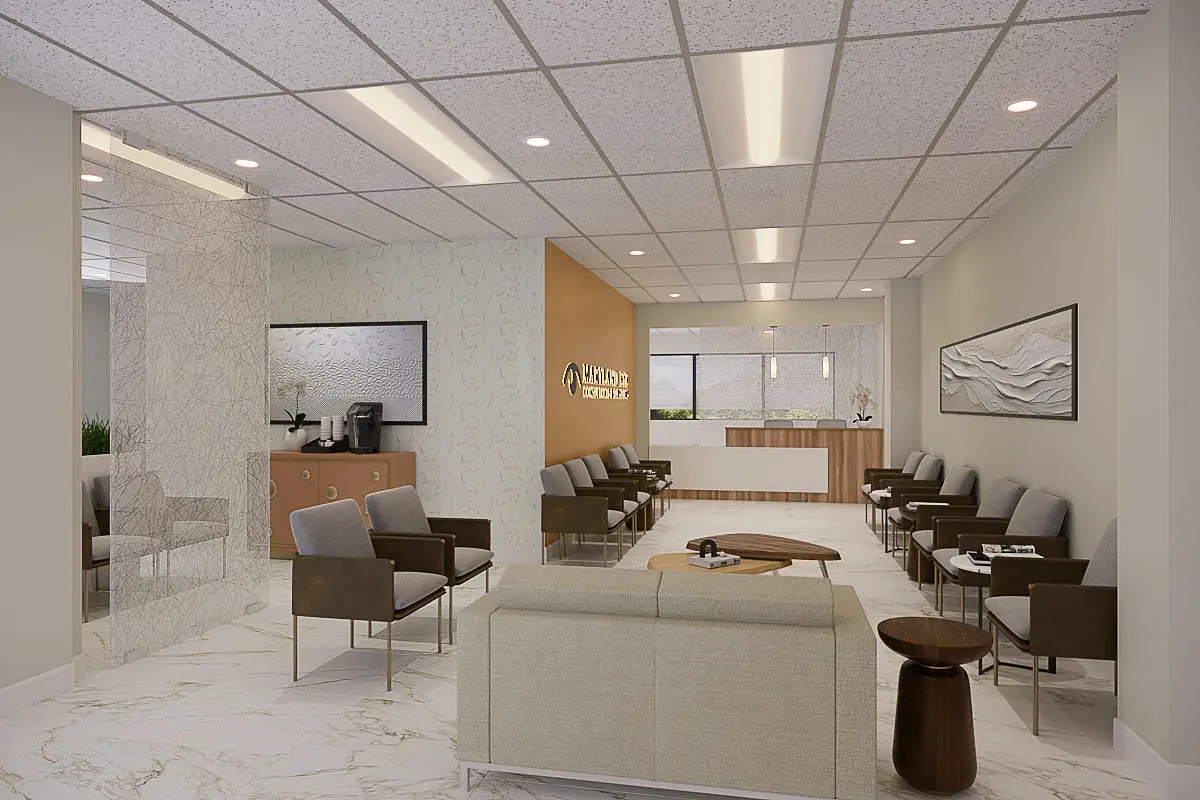Waiting area with brown chairs, beige sofas, wooden tables, light paneling, and linear ceiling lights.