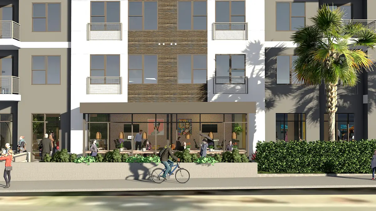 Exterior front view of a multi-story building with patio, seating, palm trees, and people.