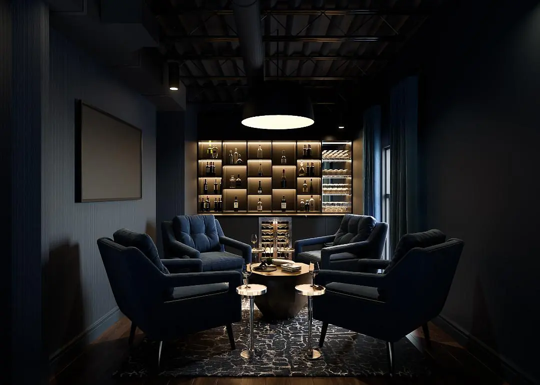 Dark room with four blue armchairs, round coffee table, and a bar shelving unit displaying bottles and glassware.
