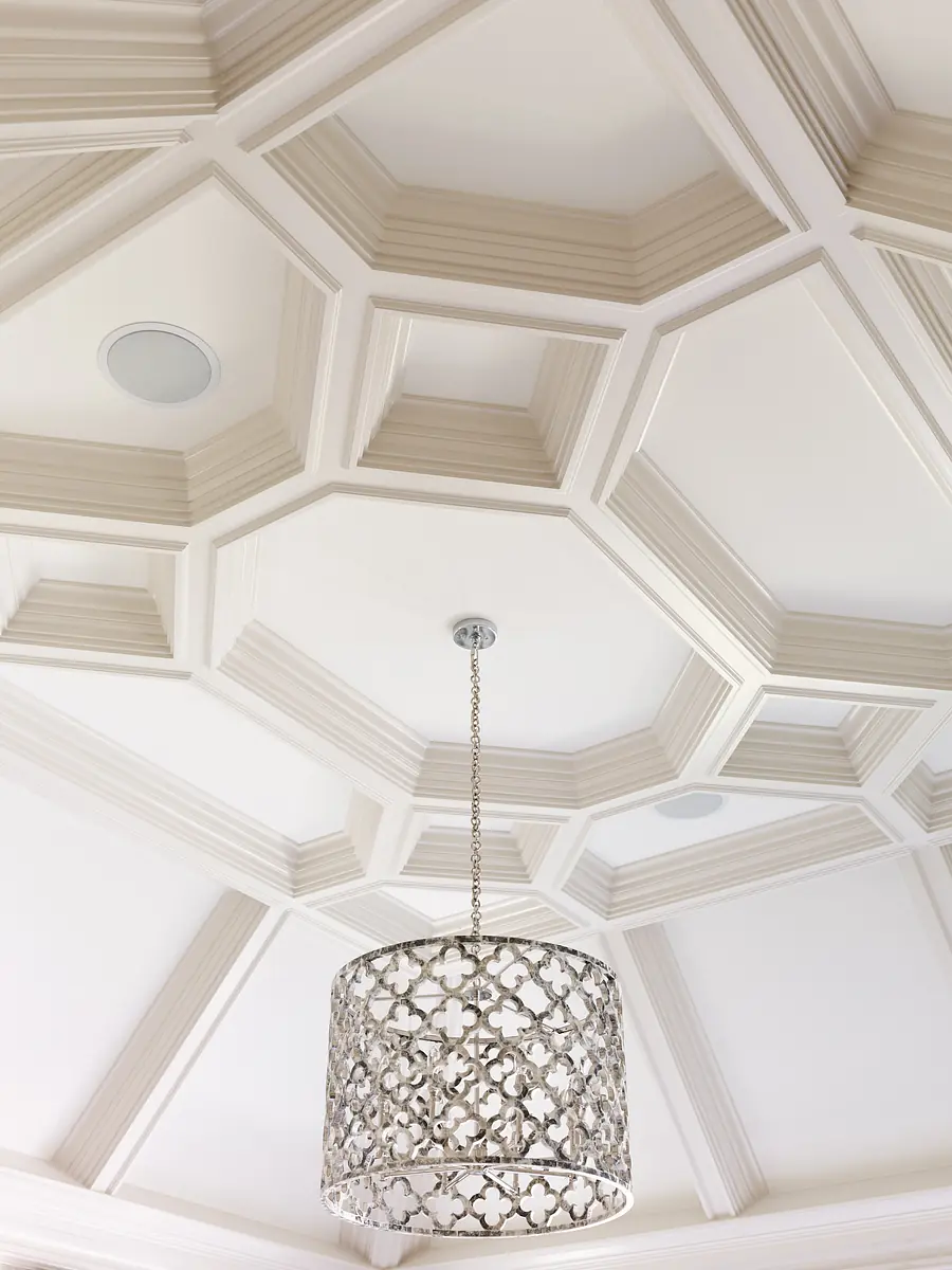 Coffered ceiling with decorative pendant light and recessed lights.