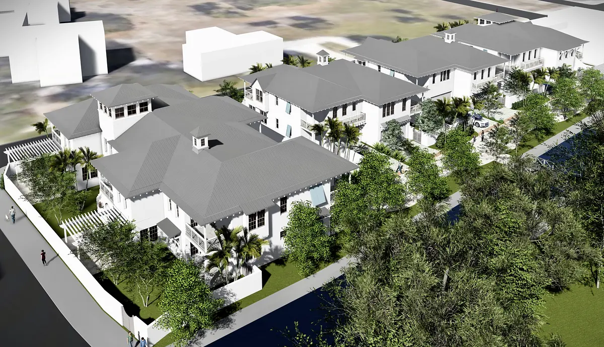 Exterior front view of residential buildings with pitched roofs, balconies, and landscaped gardens.