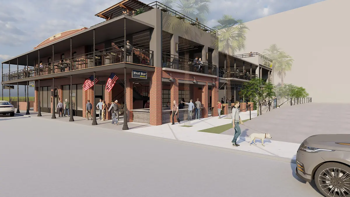 Exterior front view of a two-story brick building with balconies, flags, pedestrians, and parked vehicles.