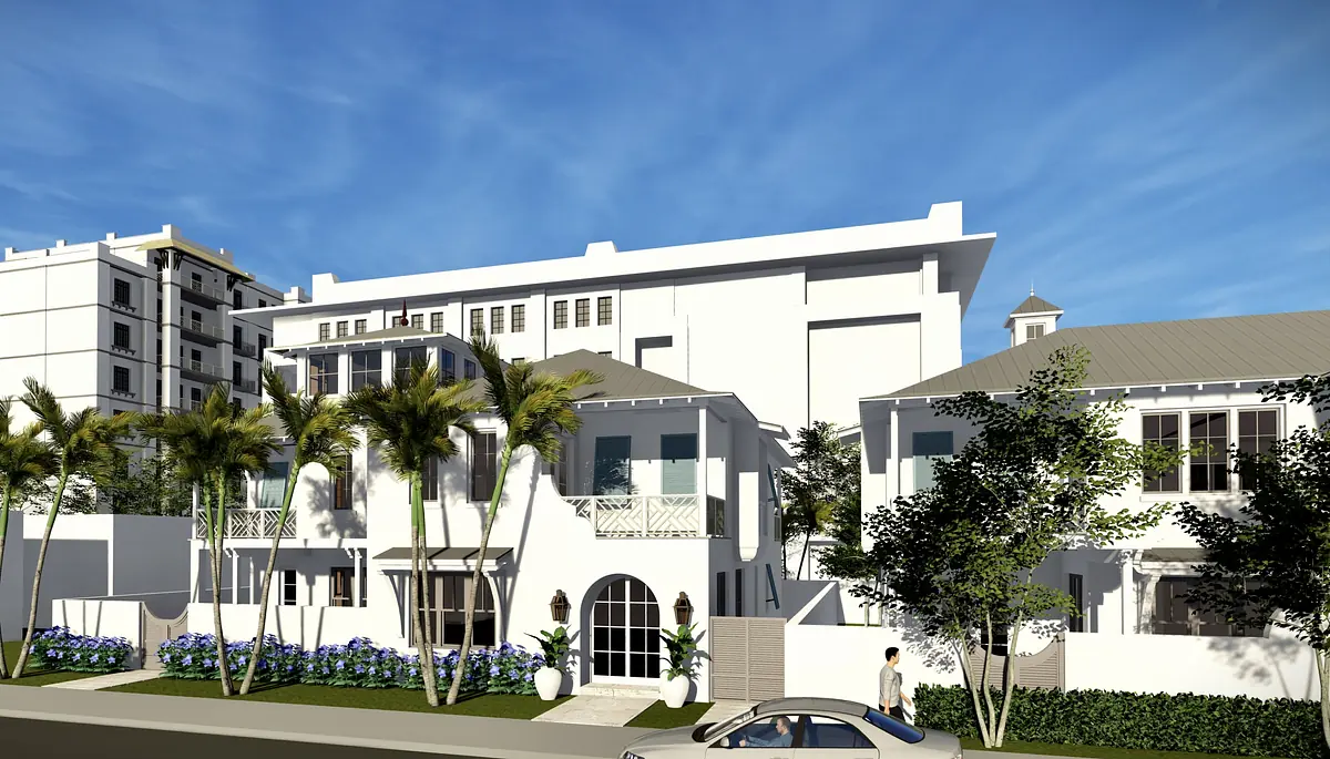 Front exterior with white stucco walls, gabled roofs, balcony, palm trees, and landscaped flower beds.
