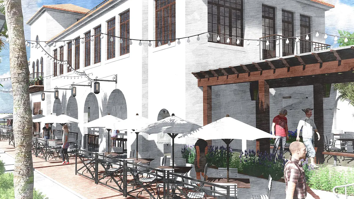 Exterior front area with a building, outdoor seating, umbrellas, string lights, and paved brick ground