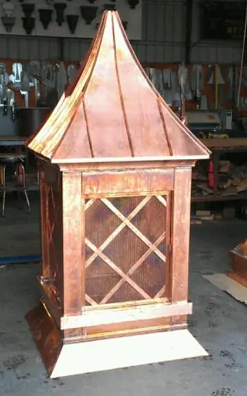 Structure with copper roof, wooden sides, and lattice design.