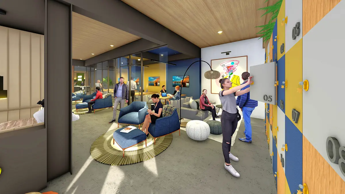 Activity area with blue lounge chairs, climbing wall, coffee table, and natural light from large windows.