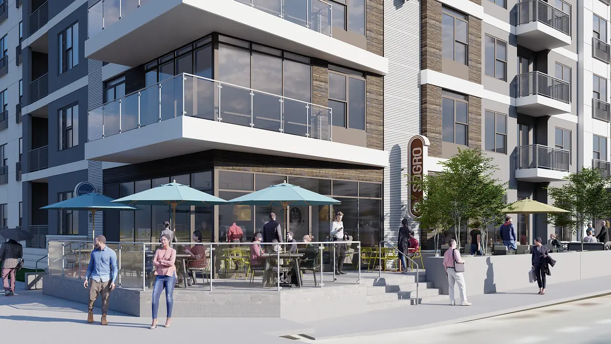 Exterior front view of a multi-story building with large windows, patios, and people socializing.