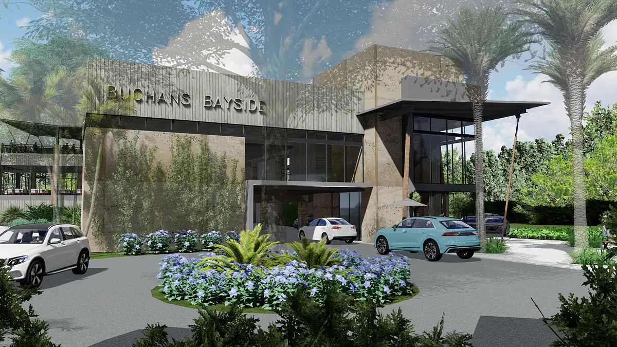 Exterior front view of a building with large glass windows, landscaped entrance, and parked cars.