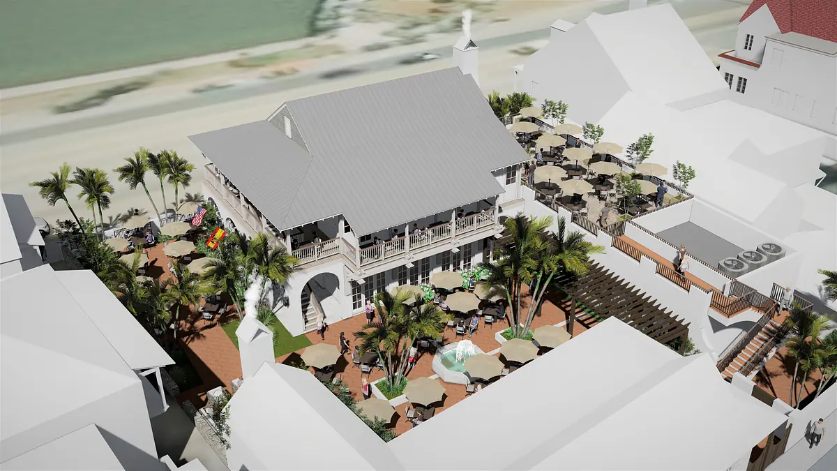 Exterior view of a multi-story building with outdoor seating, palm trees, and a pool area.