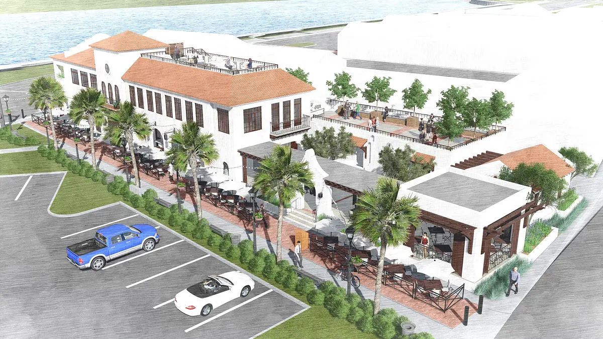 Exterior front view of a building with patio area, palm trees, and parked cars.