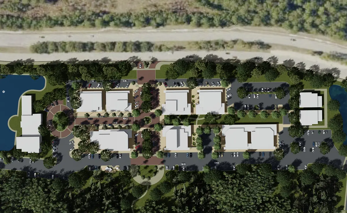 Aerial view of a residential development with multiple buildings and green landscaping.