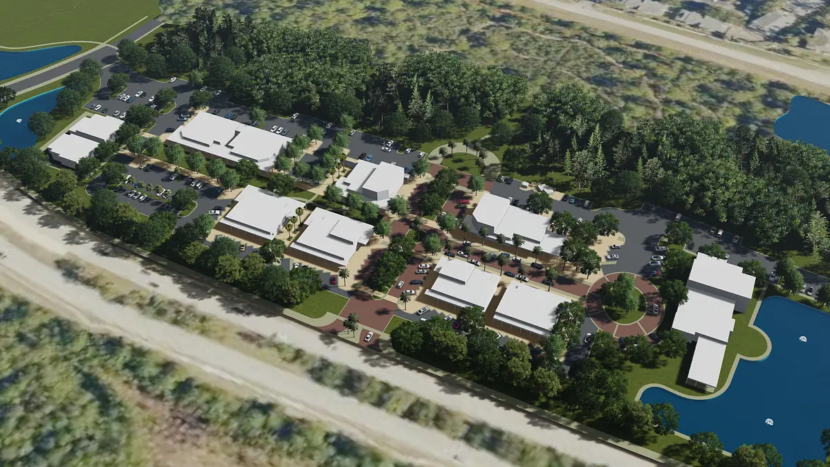 Aerial view of multiple buildings, parking spaces, pathways, trees, and water bodies in a landscaped area.