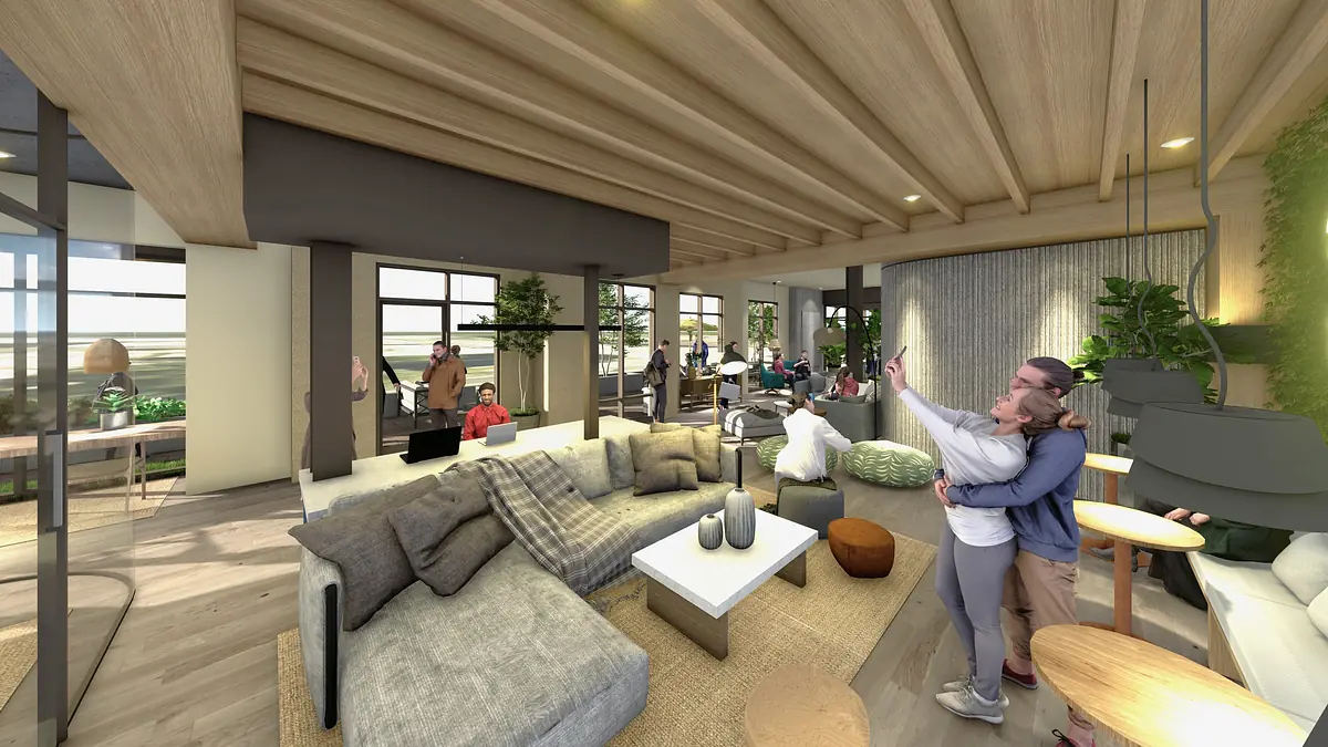 Living room with gray sectional sofa, white coffee table, plants, large windows, and wooden beams.