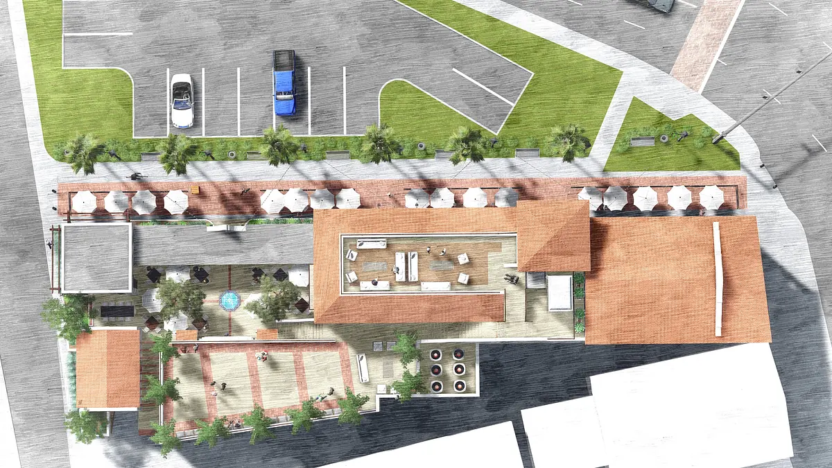 Aerial view of an outdoor space with a pool, seating areas, trees, and parking spaces.