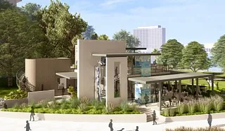 Modern building exterior with large windows, flat roof, and landscaped areas.