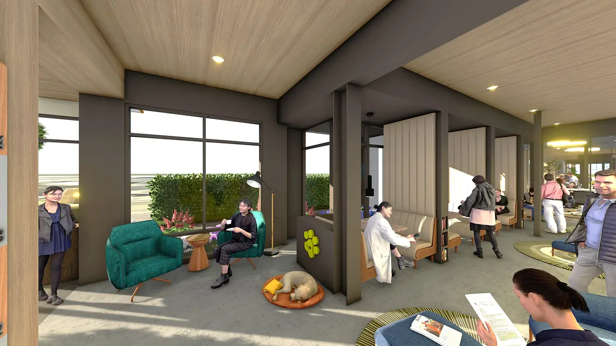 Multi-functional space with blue chair, wooden tables, partitioned seating, and large windows with greenery.